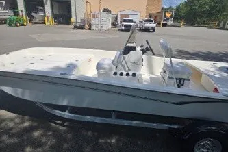 Slide: The Image of 2027 Mako Pro Skiff 17 CC boat in a parking lot, side view. - 4