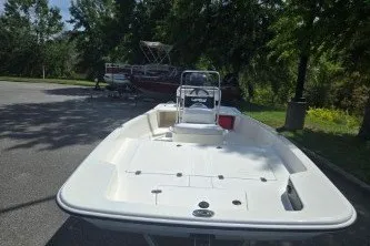 Slide: The Image of 2027 Mako Pro Skiff 17 CC boat parked outdoors on a sunny day. - 1