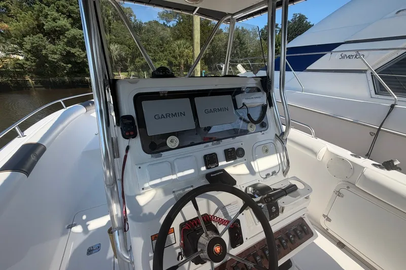 Slide: The Image of 2001 Century 2900 Center Console boat with Garmin navigation system and steering wheel. - 19