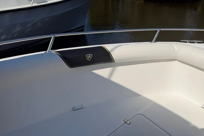 Slide: The Image of Century 2900 Center Console 2001 boat interior with cushioned seating and railing. - 14