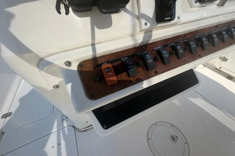 Slide: The Image of Control panel of a 2001 Century 2900 Center Console boat with various switches. - 22