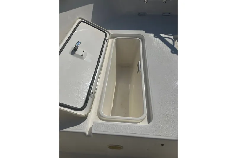 Slide: The Image of Open storage compartment on a 2001 Century 2900 Center Console boat. - 61