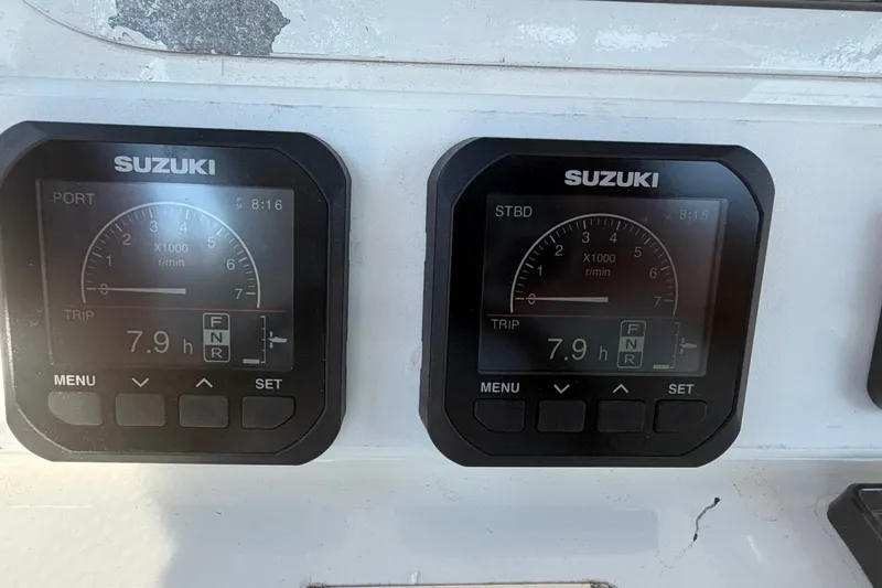 Slide: The Image of Suzuki engine gauges on a 2001 Century 2900 Center Console boat, showing 7.9 hours. - 37