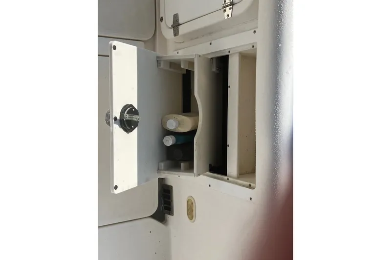 Slide: The Image of Open storage compartment on a 2001 Century 2900 Center Console boat. - 62