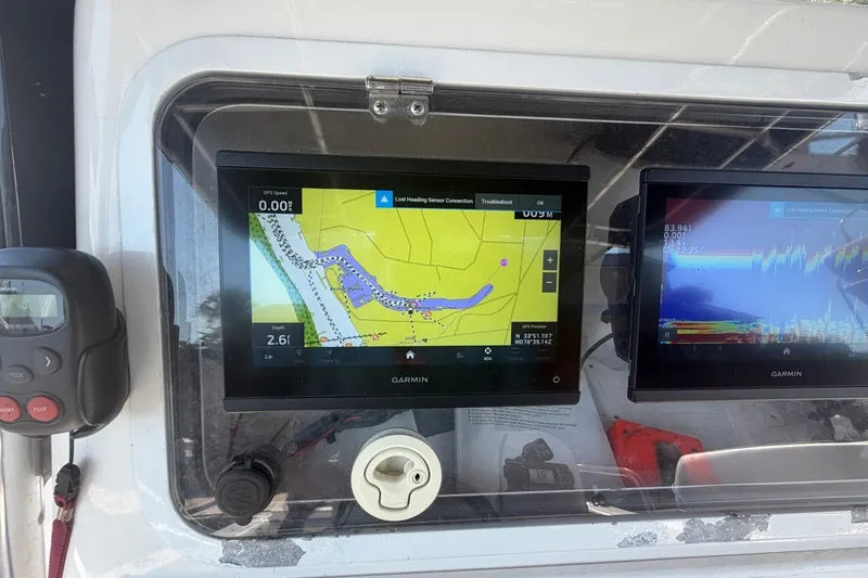 Slide: The Image of Garmin navigation screens on a 2001 Century 2900 Center Console boat dashboard. - 28