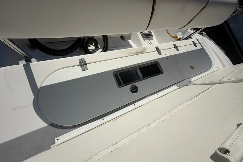Slide: The Image of 2001 Century 2900 Center Console boat interior with storage compartment and seating. - 45