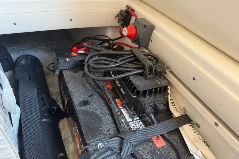 Slide: The Image of Battery compartment of a 2001 Century 2900 Center Console boat with wiring and charger. - 16