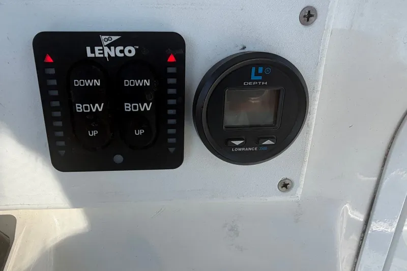 Slide: The Image of Control panel with Lenco trim tab switches and Lowrance depth gauge on a 2001 Century 2900 Center Console. - 39