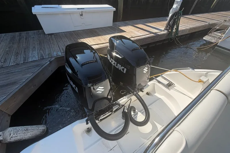 Slide: The Image of Century 2900 Center Console 2001 with dual Suzuki outboard motors docked at a marina. - 42