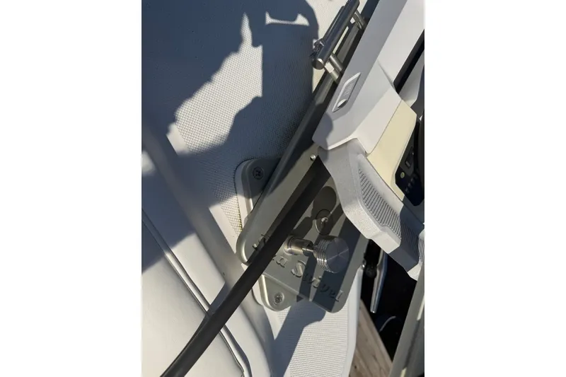 Slide: The Image of Close-up of a 2001 Century 2900 Center Console boat component, featuring a metal bracket and handle. - 8