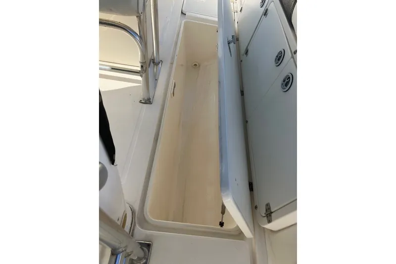 Slide: The Image of Open storage compartment on a 2001 Century 2900 Center Console boat. - 56