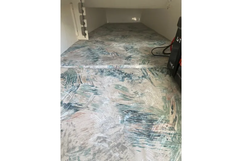 Slide: The Image of Interior view of a 2001 Century 2900 Center Console boat with patterned flooring. - 64