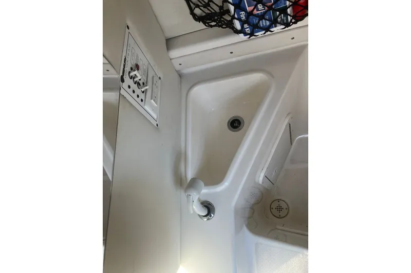 Slide: The Image of Interior view of a 2001 Century 2900 Center Console boat, featuring a sink and control panel. - 66