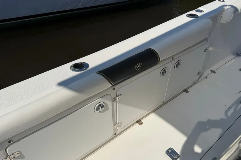 Slide: The Image of 2001 Century 2900 Center Console boat interior with storage compartments and seating. - 18
