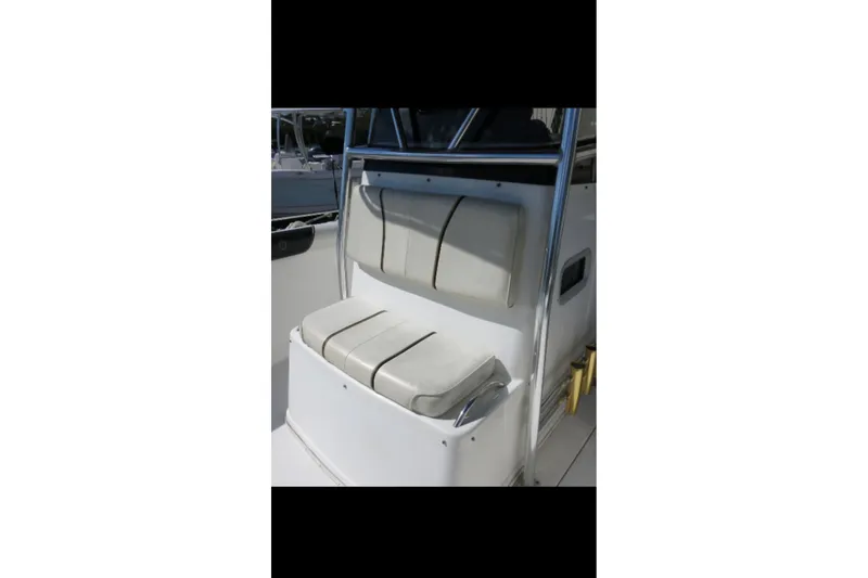 Slide: The Image of Century 2900 Center Console 2001 boat seating area with cushioned seats and stainless steel frame. - 52