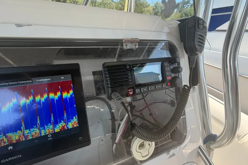 Slide: The Image of Center console of a 2001 Century 2900 boat with navigation equipment and radio. - 30