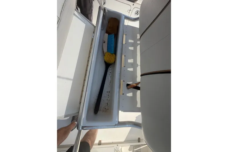 Slide: The Image of Storage compartment on a 2001 Century 2900 Center Console boat with cleaning tools. - 26