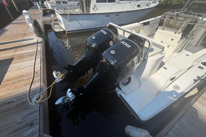 Slide: The Image of 2001 Century 2900 Center Console boat with dual outboard engines docked at marina. - 32
