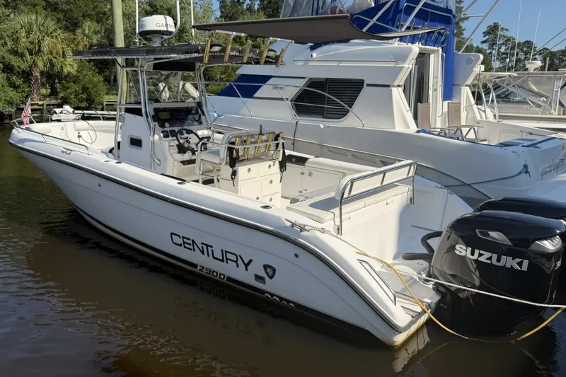 Slide: The Image of 2001 Century 2900 Center Console boat with Suzuki engines docked in marina. - 1