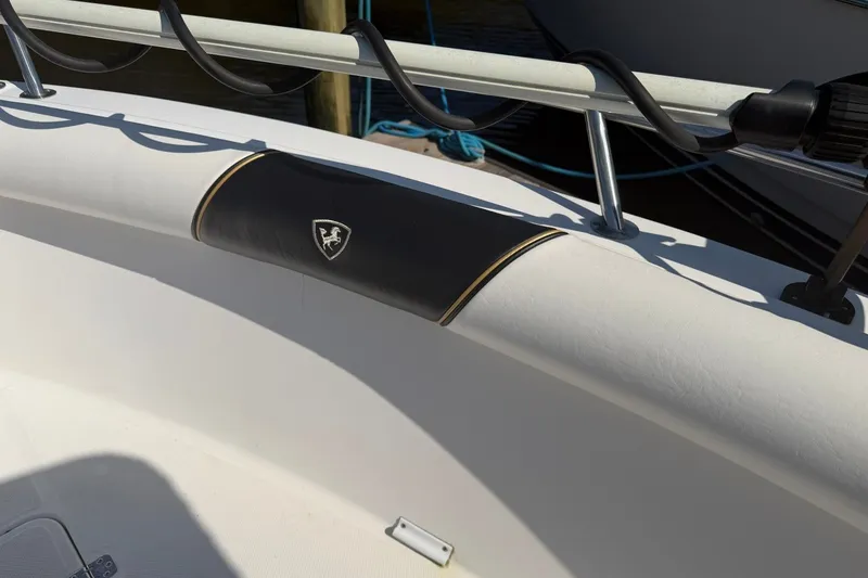 Slide: The Image of Century 2900 Center Console boat detail, 2001 model, featuring padded railing and emblem. - 13