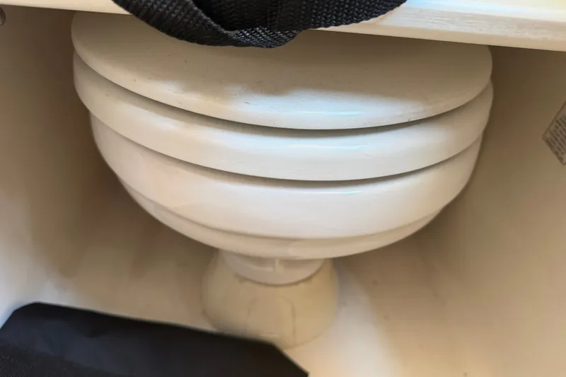 Slide: The Image of A white marine toilet inside a 2001 Century 2900 Center Console boat. - 56