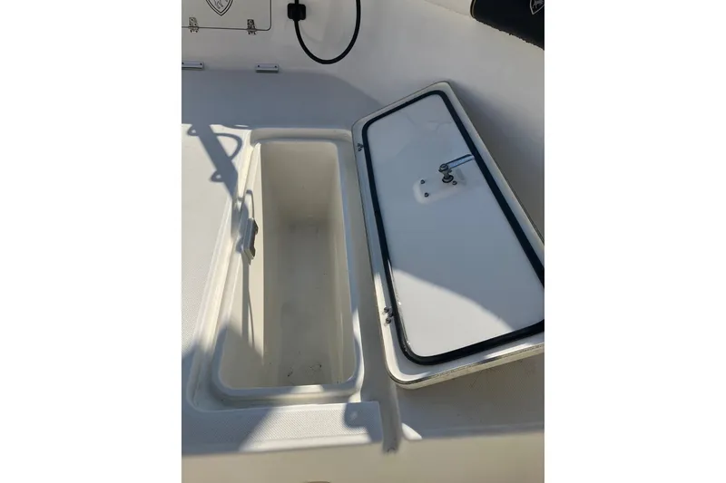 Slide: The Image of Open storage compartment on a 2001 Century 2900 Center Console boat. - 60