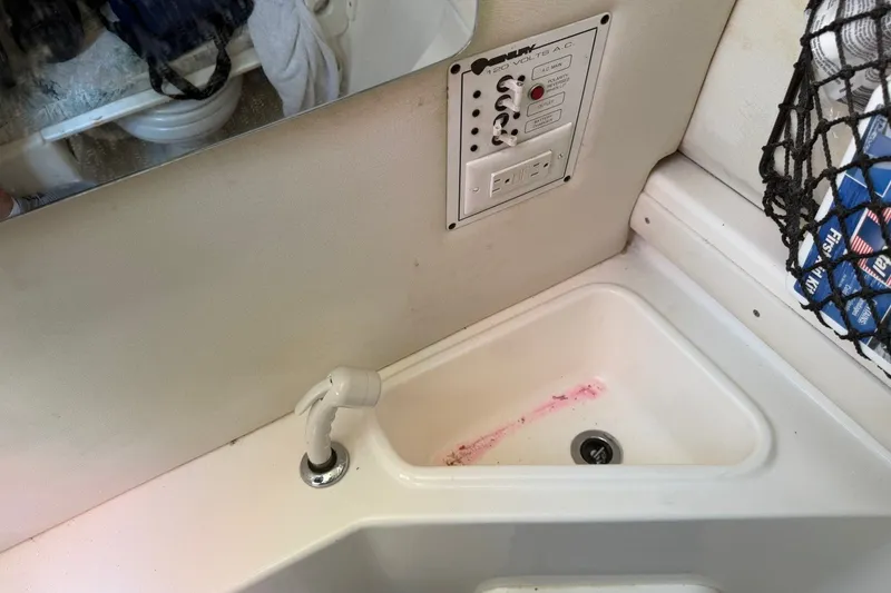 Slide: The Image of 2001 Century 2900 Center Console boat sink with faucet and control panel. - 15
