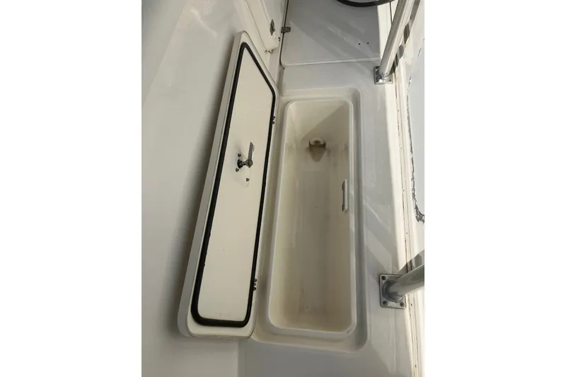 Slide: The Image of Open storage compartment on 2001 Century 2900 Center Console boat. - 59