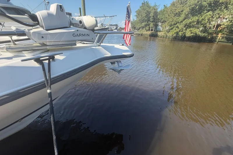 Slide: The Image of 2001 Century 2900 Center Console boat docked with Garmin equipment and American flag. - 52