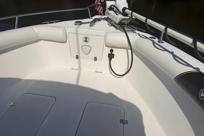 Slide: The Image of 2001 Century 2900 Center Console boat interior with white seating and storage compartments. - 10