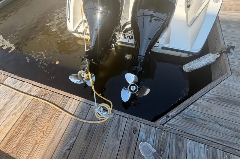 Slide: The Image of Twin outboard motors on a 2001 Century 2900 Center Console at a dock. - 33