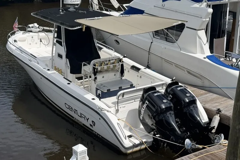 The Image of 2001 Century 2900 Center Console boat docked with twin Suzuki engines. - 0