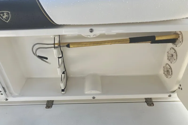 Slide: The Image of Storage compartment in a 2001 Century 2900 Center Console boat with fishing gaff. - 53
