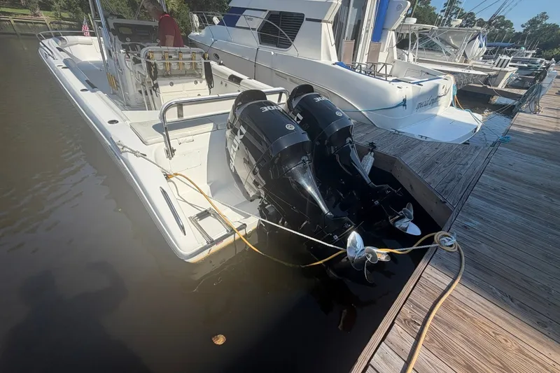Slide: The Image of 2001 Century 2900 Center Console boat docked with dual Suzuki outboard motors. - 34