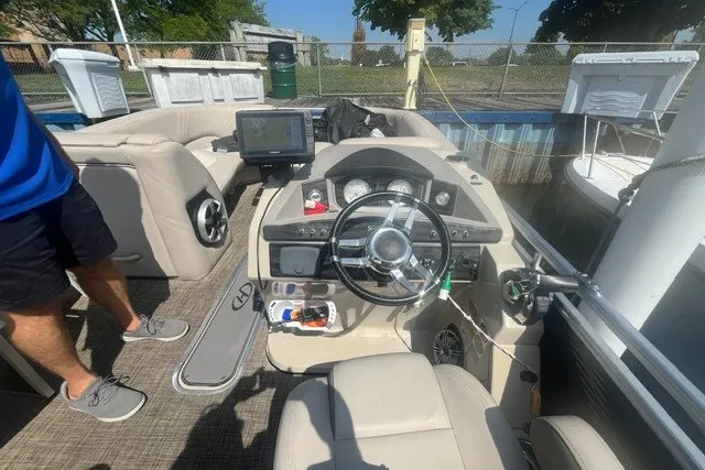 Slide: The Image of 2018 Harris Solstice 220 boat interior with steering wheel and navigation system. - 15