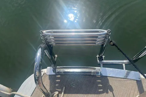 Slide: The Image of 2018 Harris Solstice 220 boat ladder reflecting sunlight on water. - 21