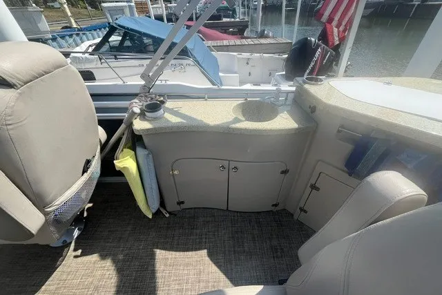Slide: The Image of 2018 Harris Solstice 220 boat interior with seating and storage area. - 17
