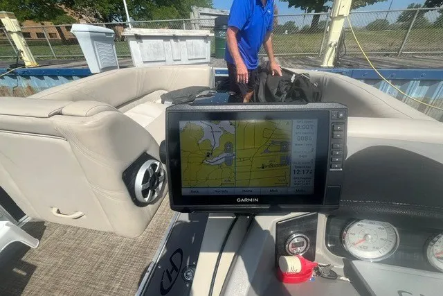 Slide: The Image of 2018 Harris Solstice 220 boat interior with Garmin navigation system and seating area. - 14