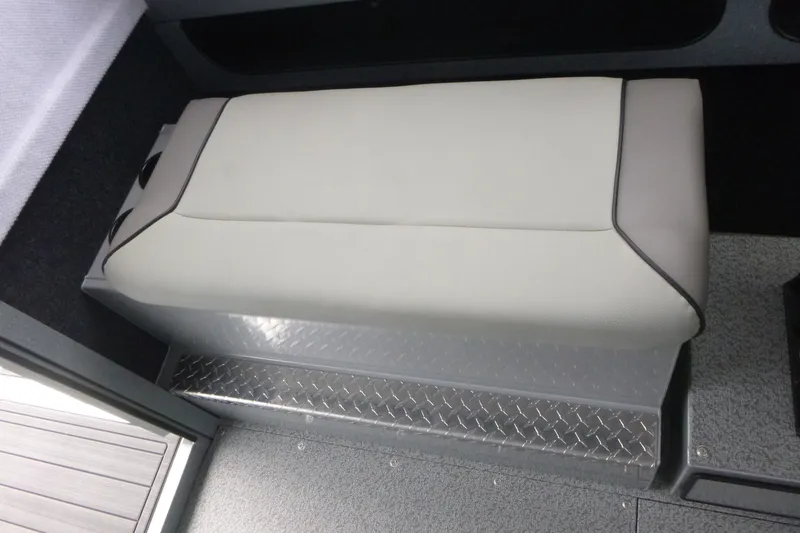 Slide: The Image of Interior seating of 2027 KingFisher 2825 Coastal Express boat, featuring cushioned bench and diamond plate flooring. - 12