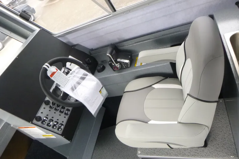 Slide: The Image of Interior of 2027 KingFisher 2825 Coastal Express boat, featuring steering wheel and control panel. - 8