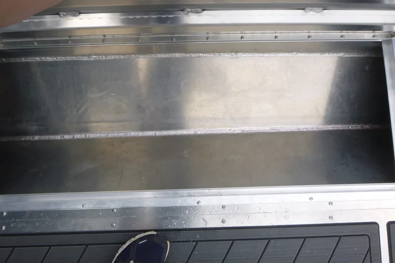 Slide: The Image of Storage compartment of 2027 KingFisher 2825 Coastal Express boat, featuring metal construction. - 16