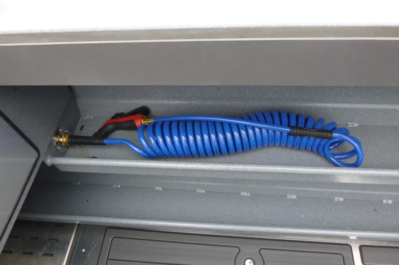 Slide: The Image of Coiled blue hose in KingFisher 2825 Coastal Express 2027 storage compartment. - 22