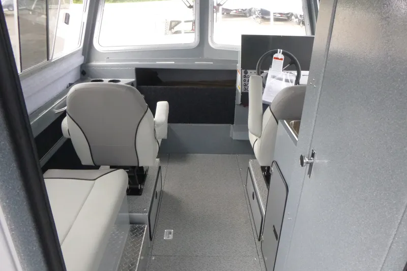 Slide: The Image of Interior of 2027 KingFisher 2825 Coastal Express boat, featuring seating and helm area. - 7