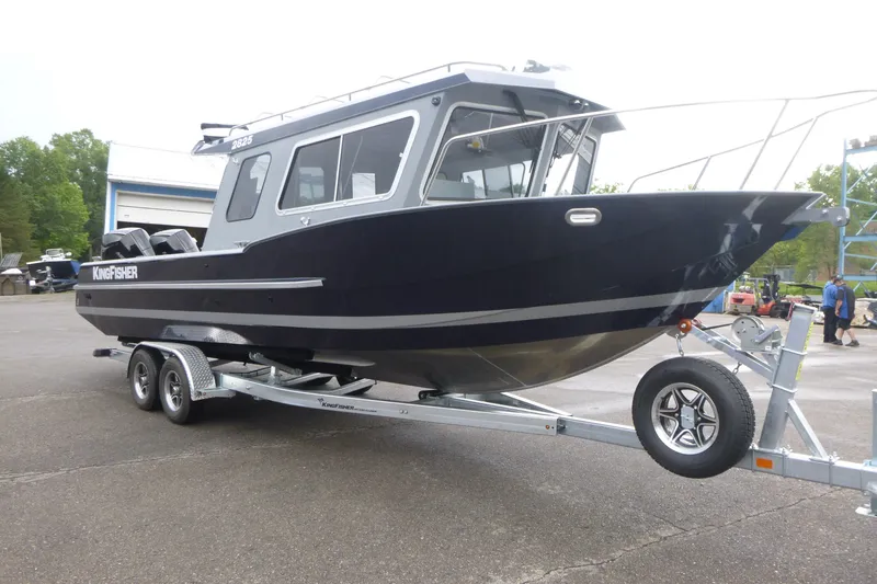 Slide: The Image of 2027 KingFisher 2825 Coastal Express boat on trailer, parked outdoors. - 3