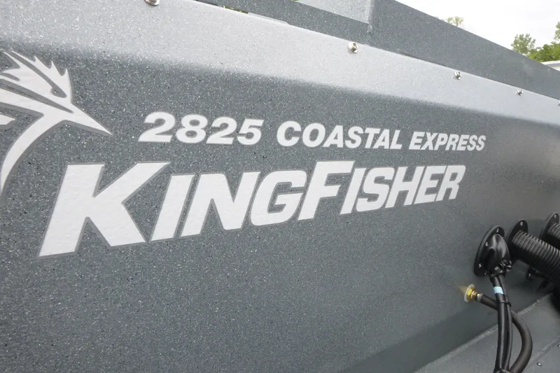 Slide: The Image of 2027 KingFisher 2825 Coastal Express boat branding on gray surface. - 25