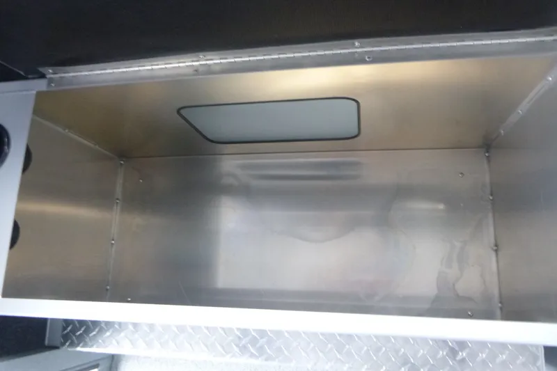 Slide: The Image of Storage compartment inside 2027 KingFisher 2825 Coastal Express boat, featuring metal interior. - 13