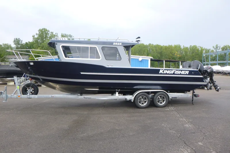 Slide: The Image of 2027 KingFisher 2825 Coastal Express boat on trailer, parked outdoors. - 4