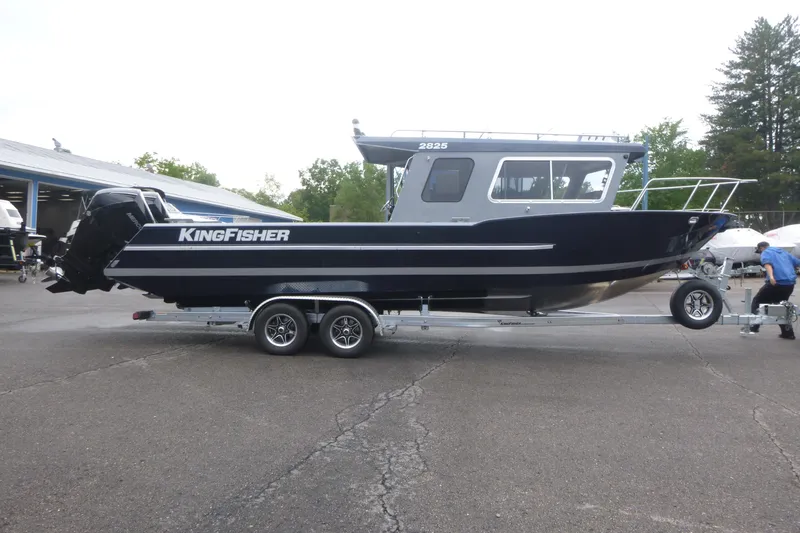 The Image of 2027 KingFisher 2825 Coastal Express boat on trailer in outdoor setting. - 1