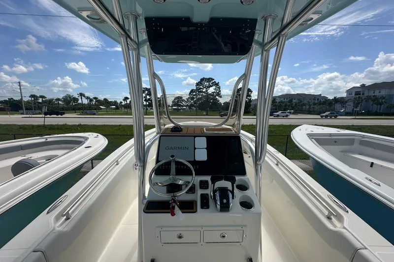 Slide: The Image of 2027 Bulls Bay 255 Center Console boat with Garmin navigation, parked outdoors. - 4
