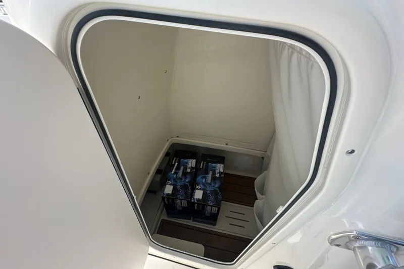 Slide: The Image of Storage compartment inside a 2027 Bulls Bay 255 Center Console boat, containing beverage packs. - 10
